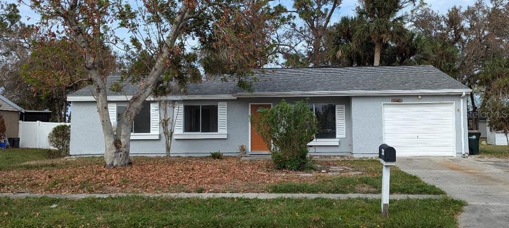 a front view of house with a garden