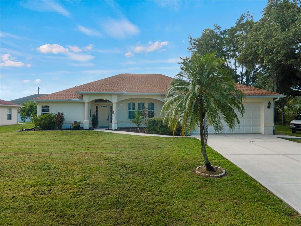 a front view of a house with a garden