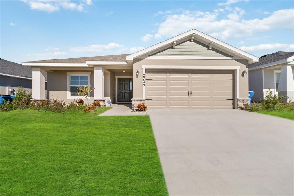 a front view of a house with a yard and garage