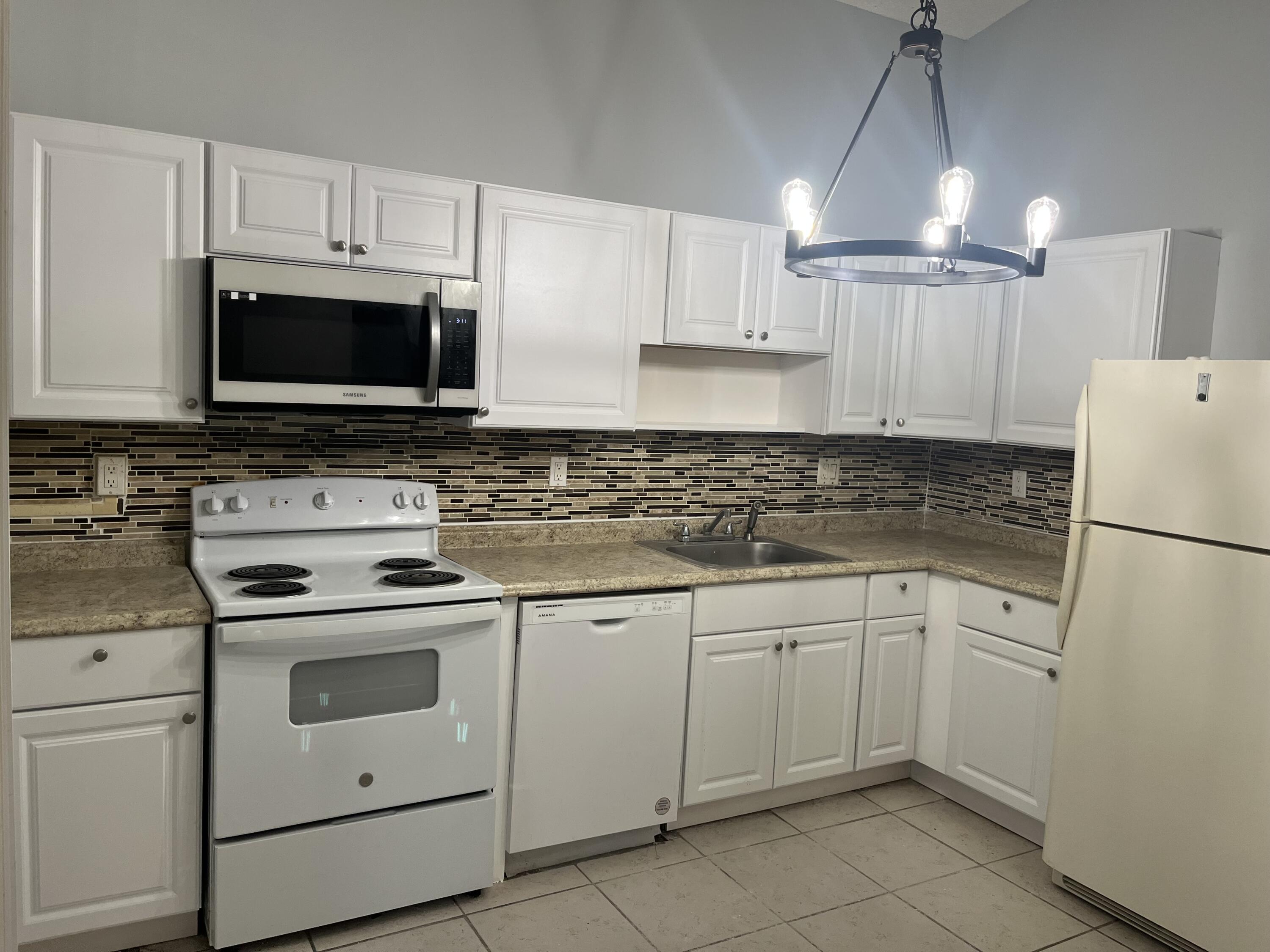 a kitchen with cabinets stainless steel appliances and a sink