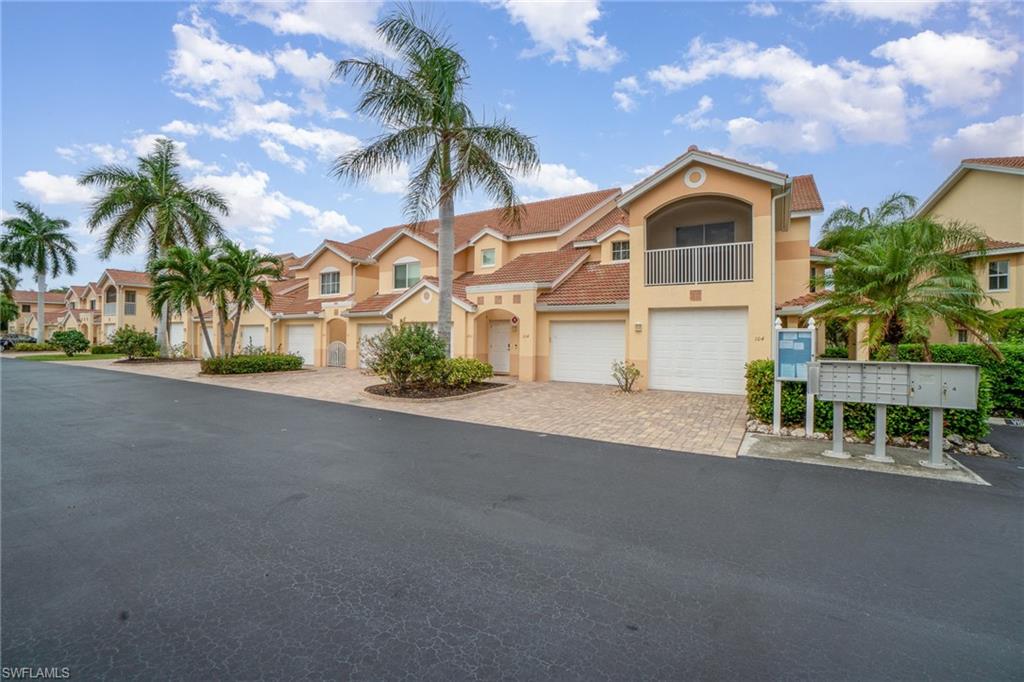 View of front of home with a balcony and a garage