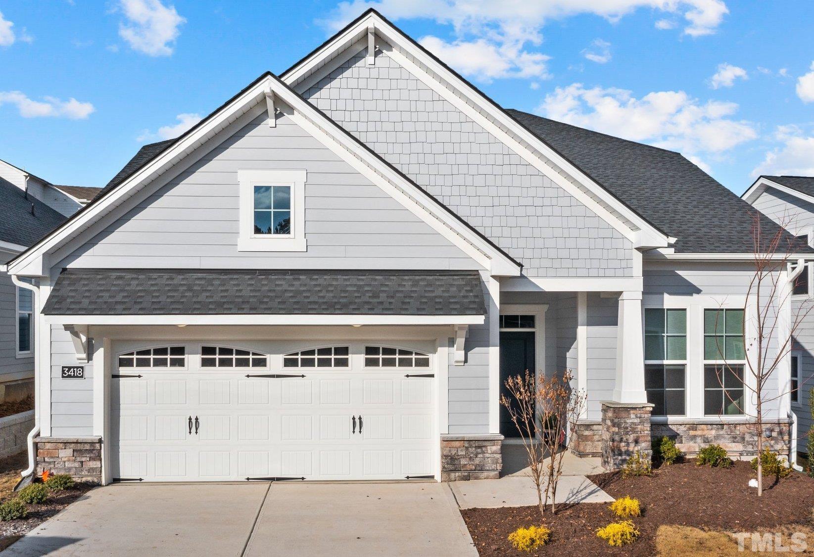 a front view of a house with garage