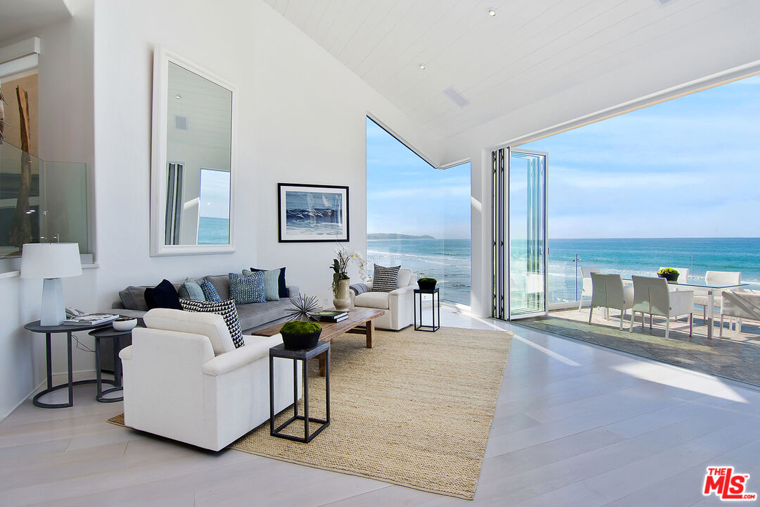 a living room with furniture and large windows