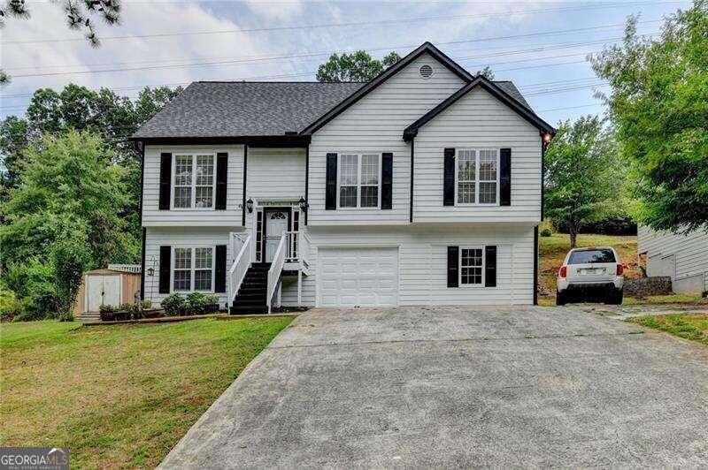 a view of house with yard and green space