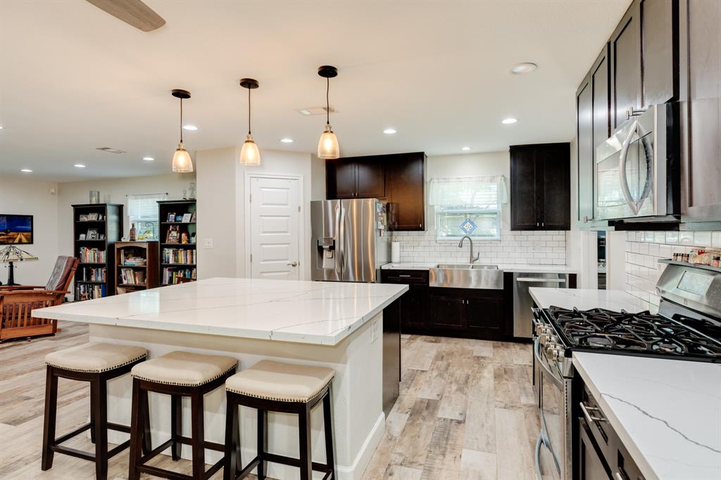 a kitchen with a table chairs stove and refrigerator