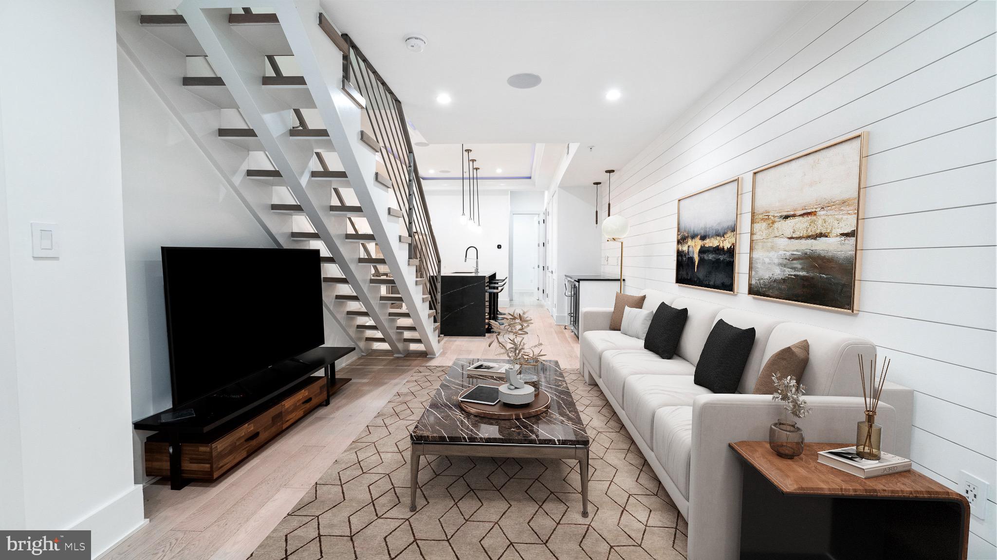 a living room with furniture a flat screen tv and a fireplace