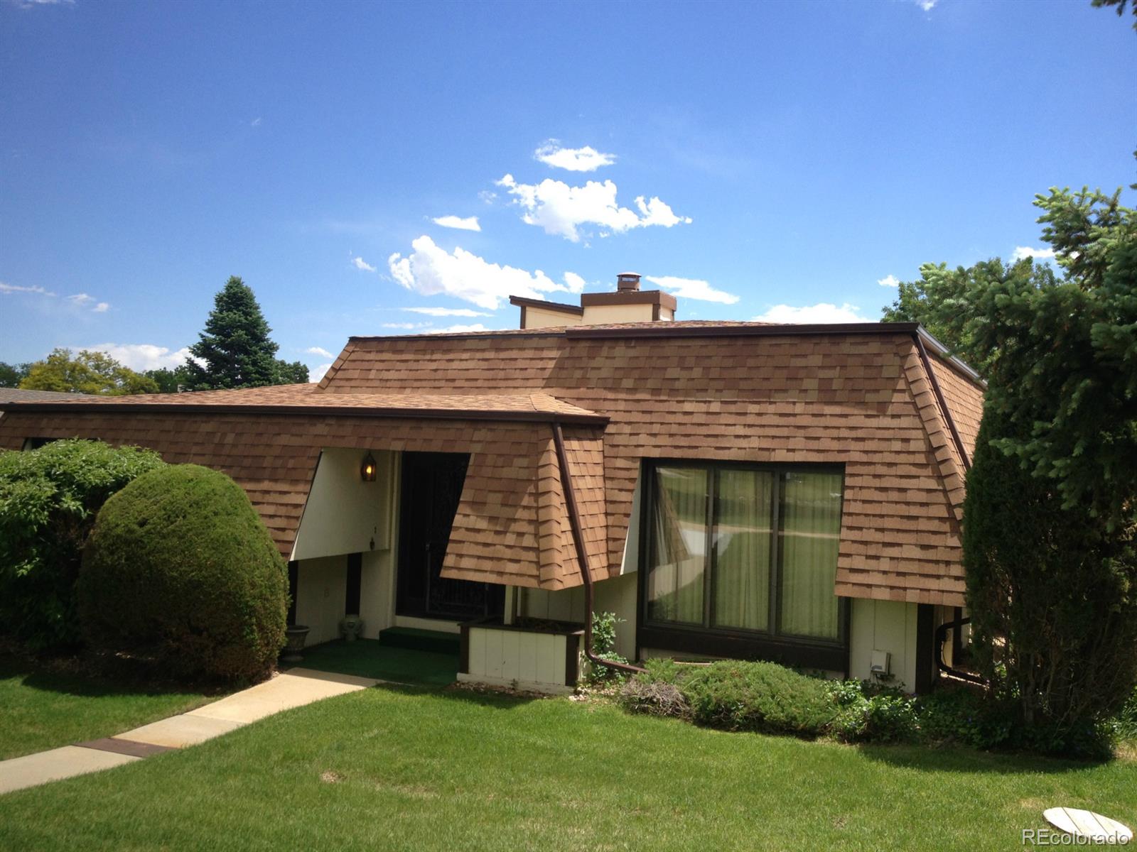 a front view of a house with a garden and plants