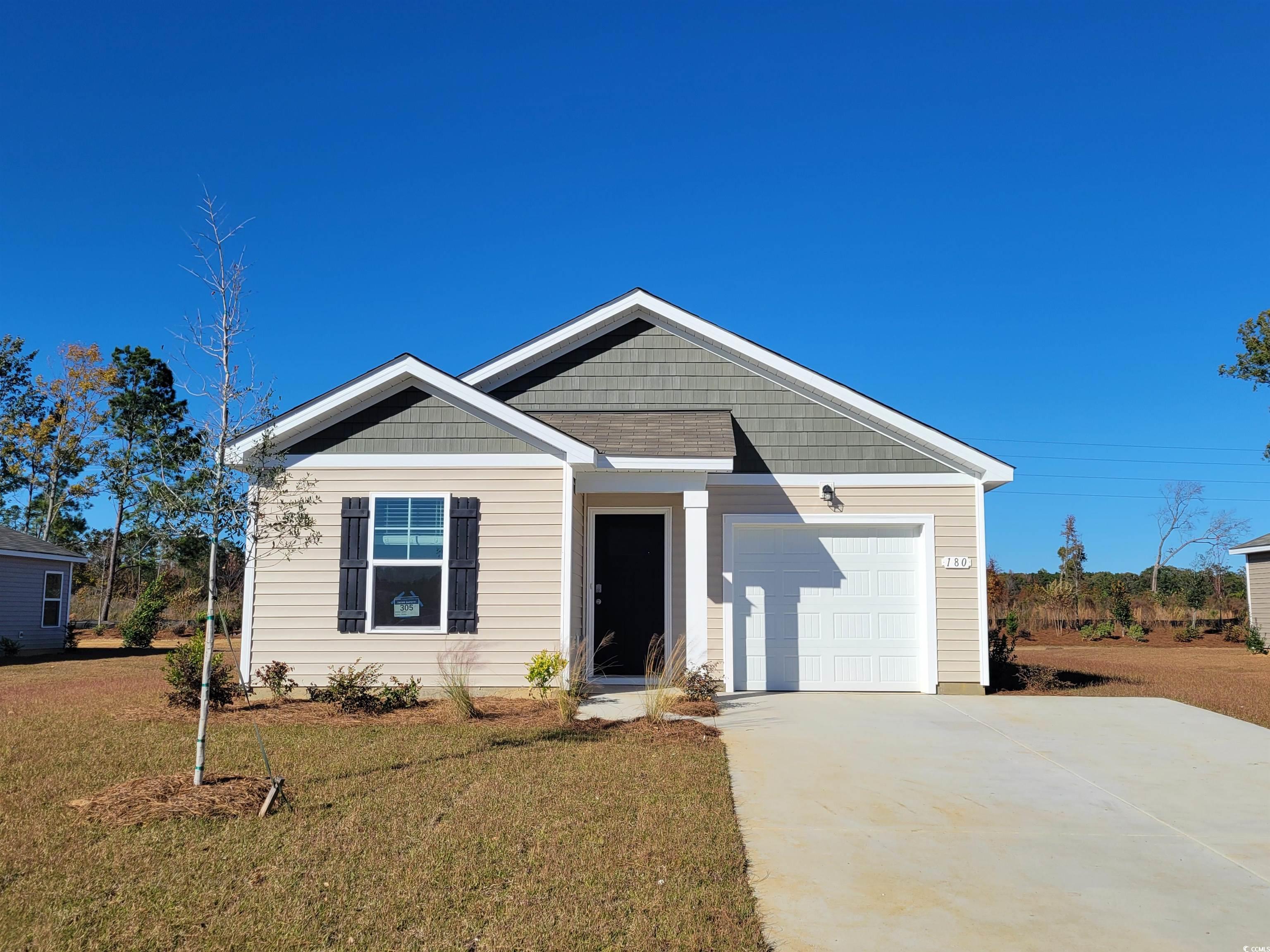 View of front of property with a front yard and a