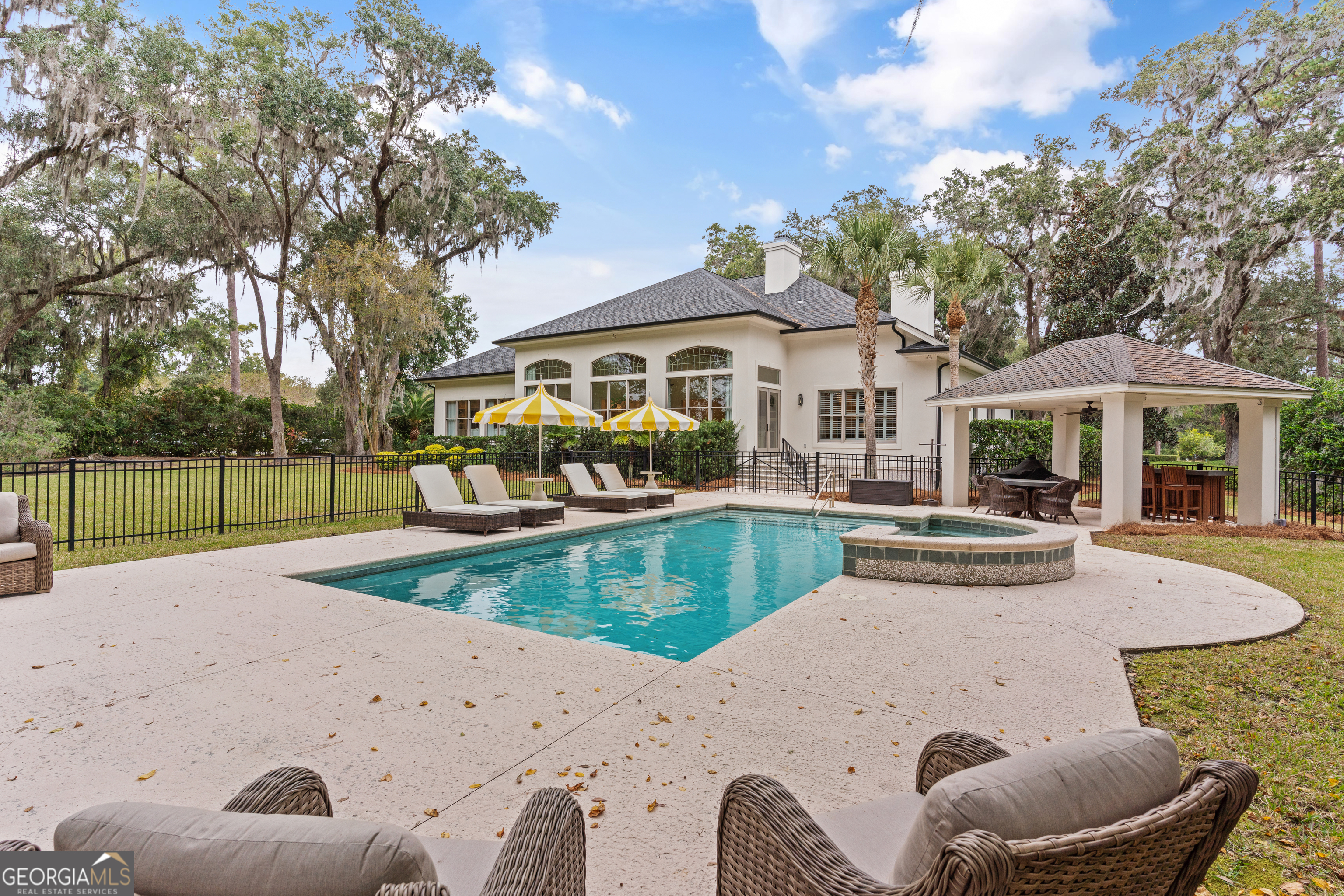 a view of a house with swimming pool and sitting area