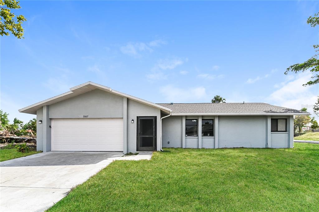 a view of an house with backyard space and garden