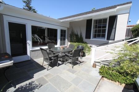 a view of a patio with table and chairs and potted plants