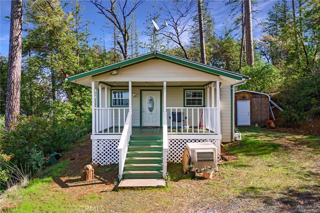 a view of a house with a yard and lawn chairs