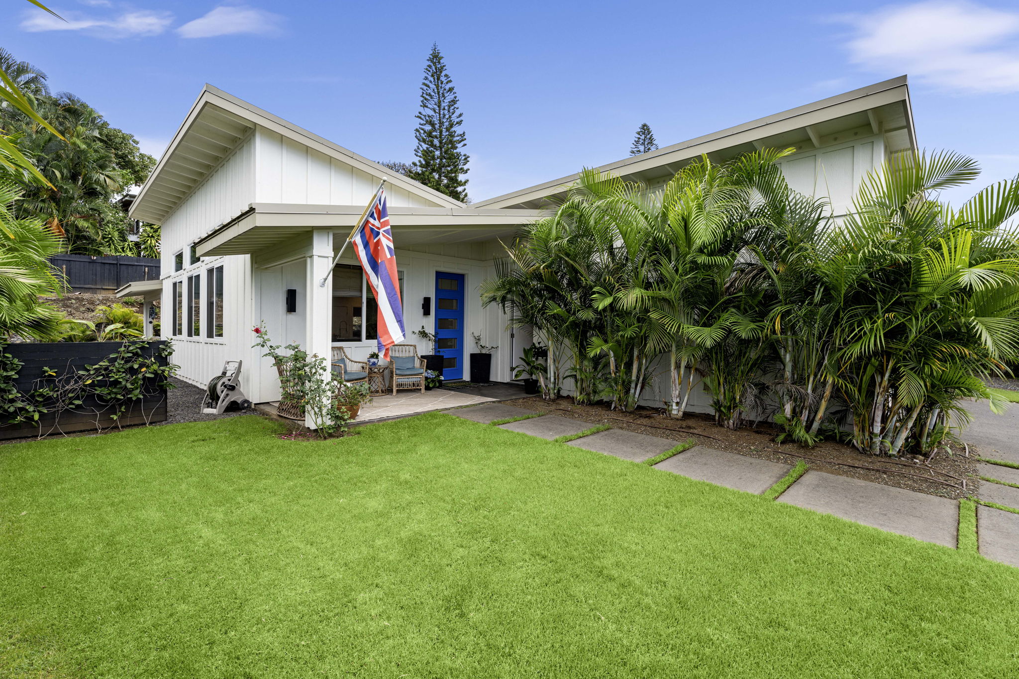 Covered front porch, looking out into the grassy front lawn. Easy access from the garage side door to the front door of the home.