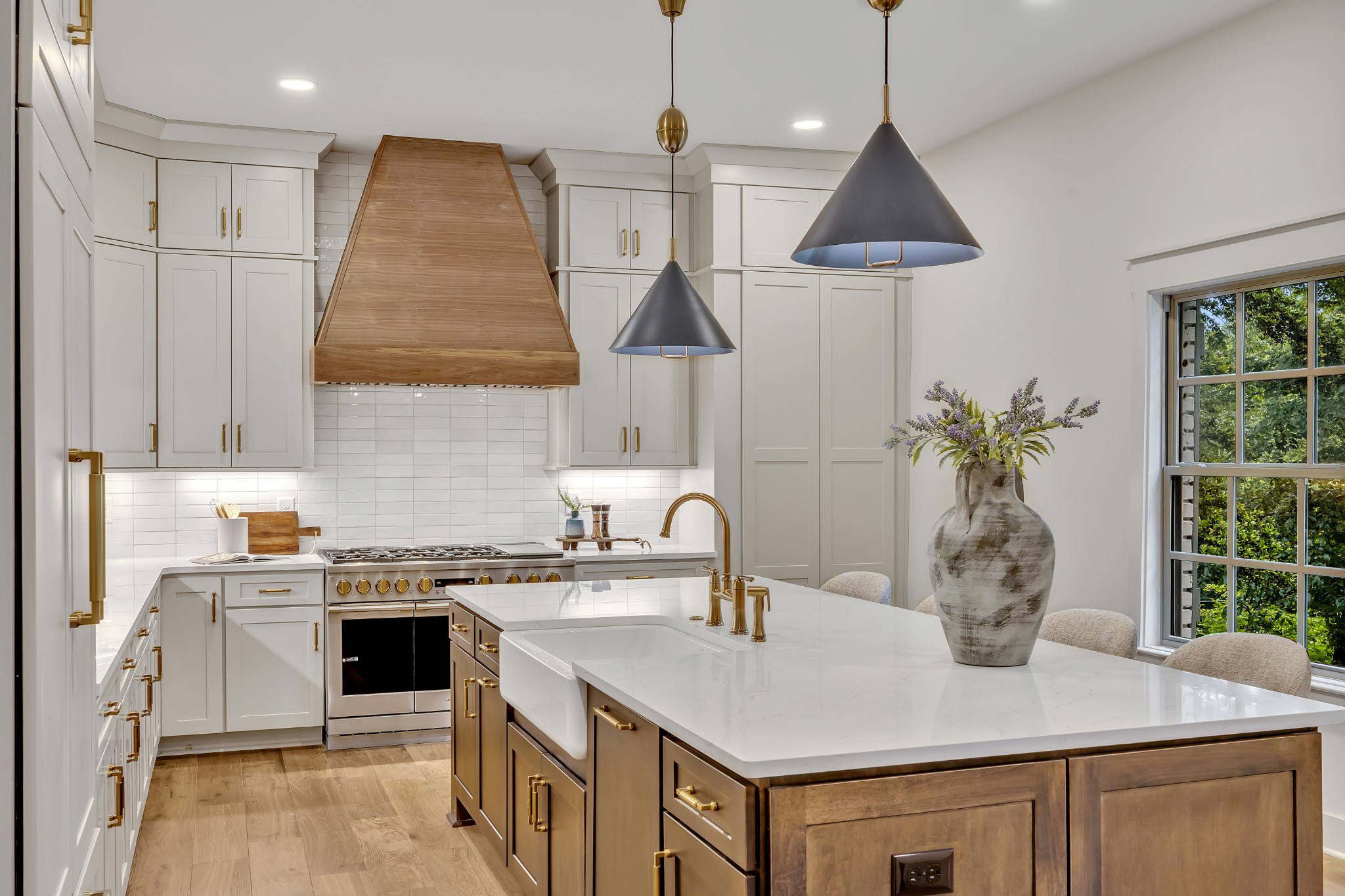 a kitchen with stainless steel appliances granite countertop a sink a stove and a wooden floors