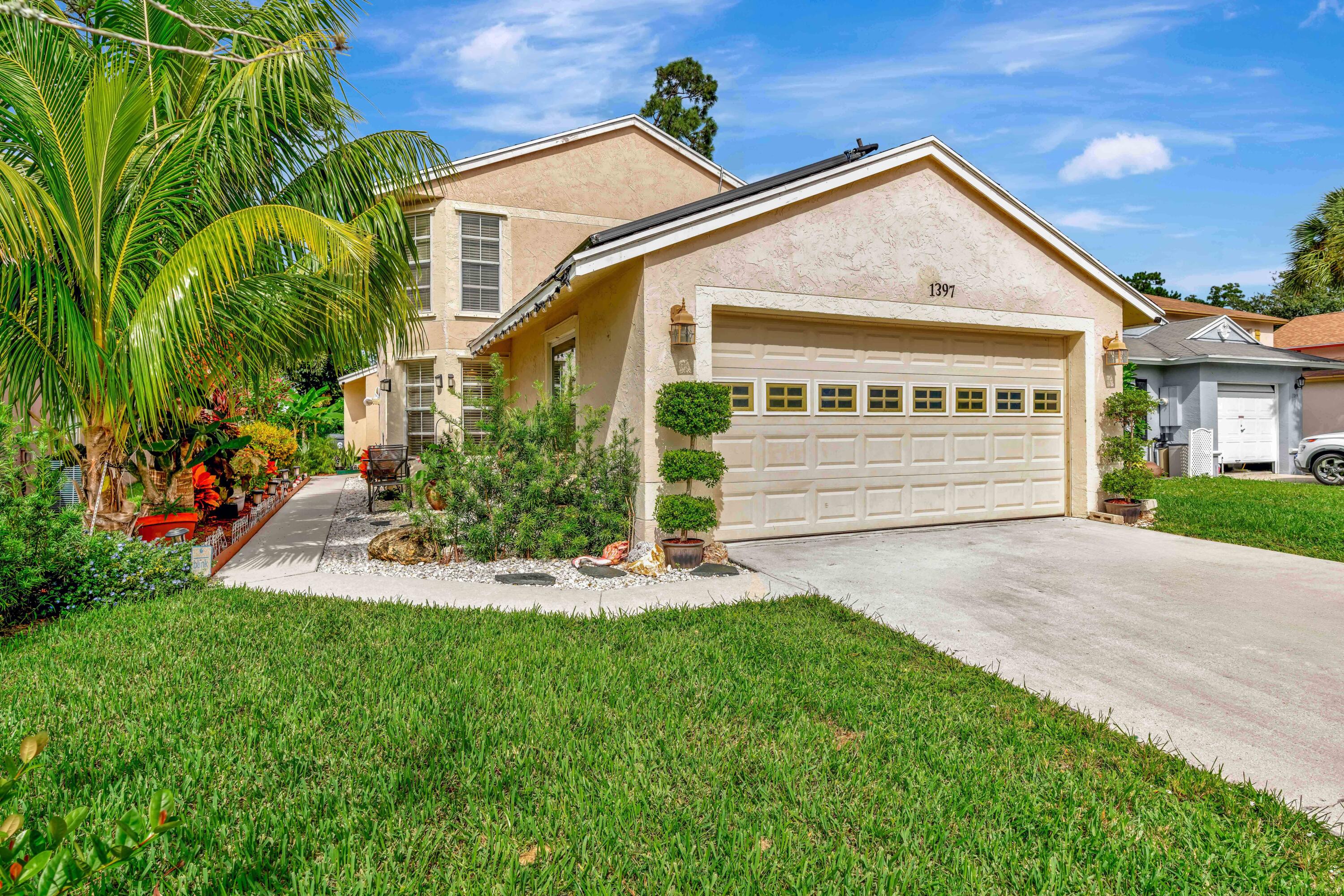 a front view of a house with a yard and garage