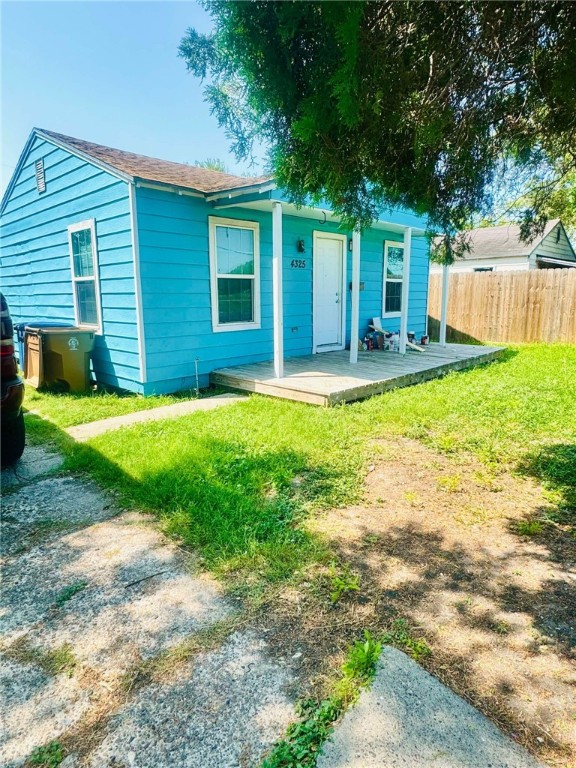 a view of a house with a yard and a patio