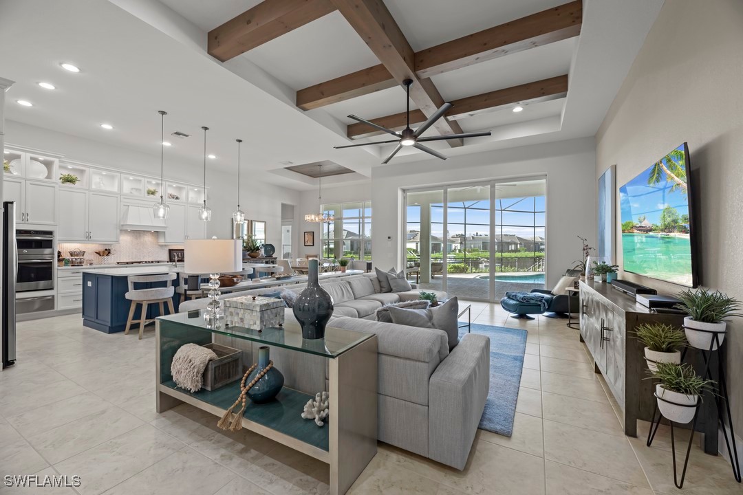 a living room with furniture kitchen view and a large window