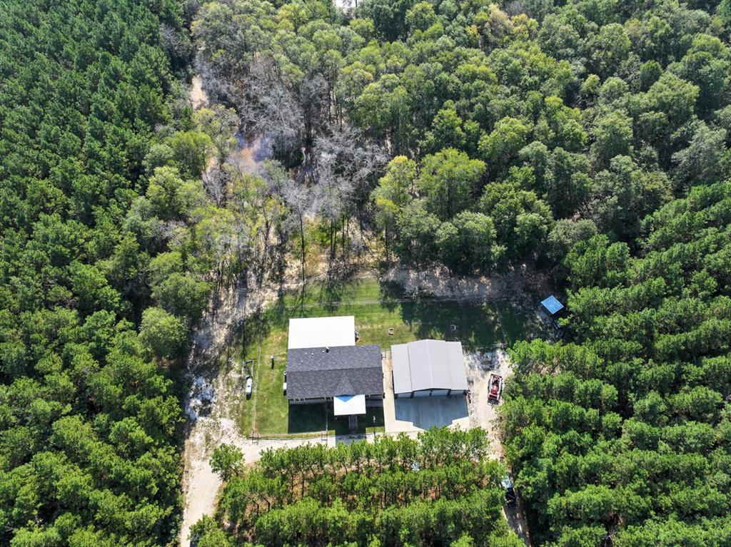 an aerial view of a house with yard