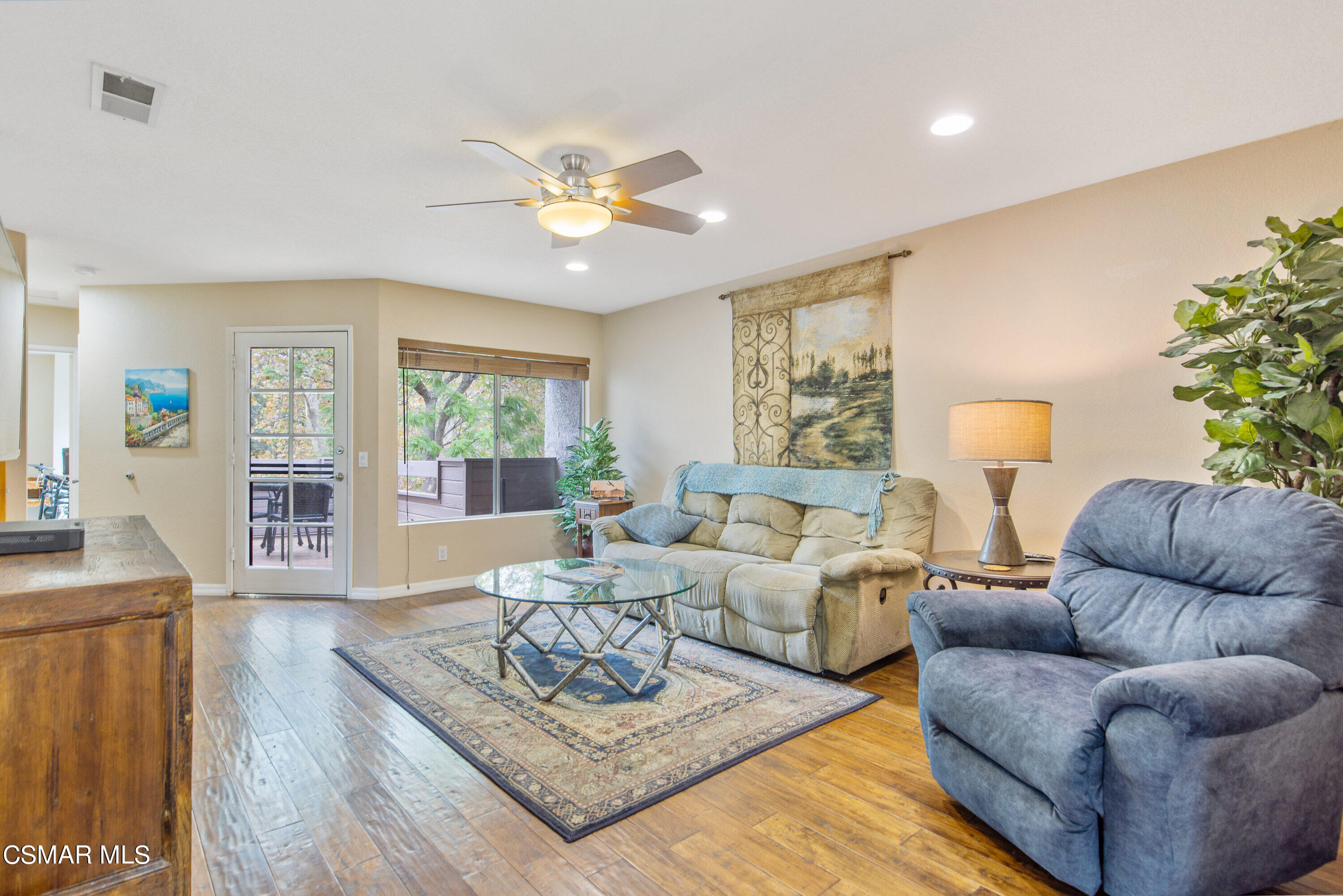 a living room with furniture or couch and a wooden floor