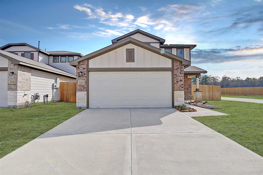 a front view of a house with a yard and garage