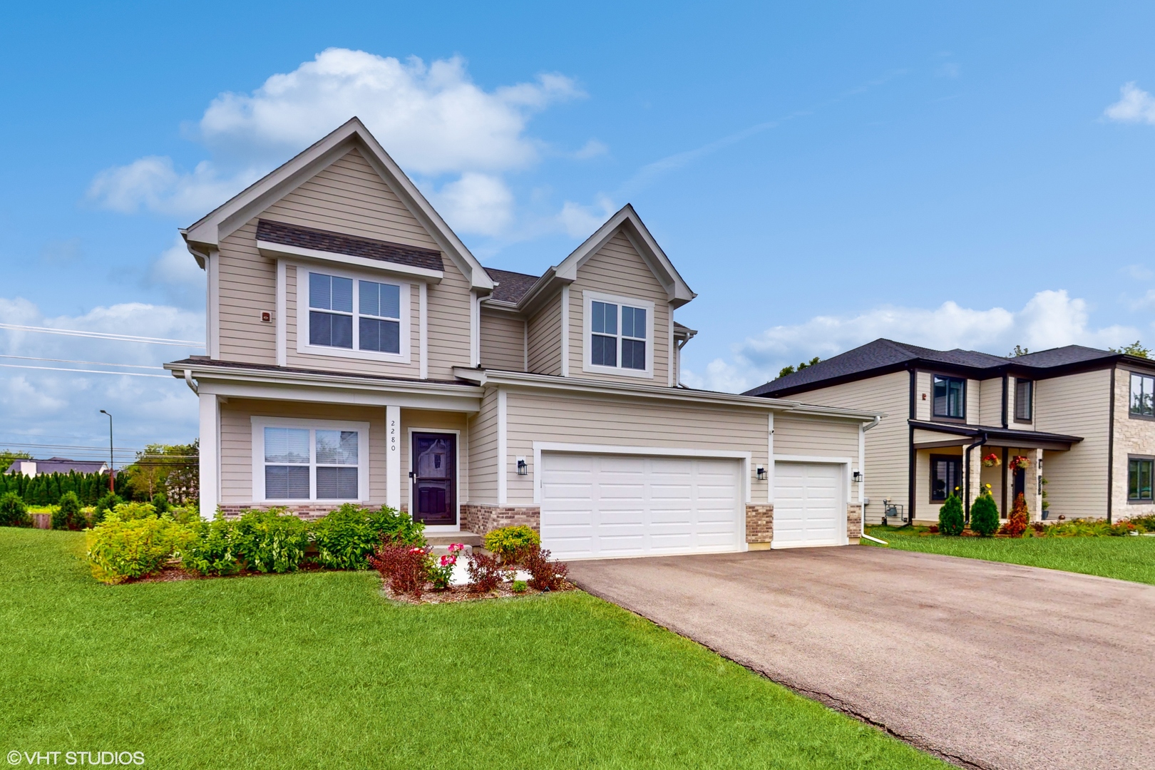 a front view of a house with a yard and garage