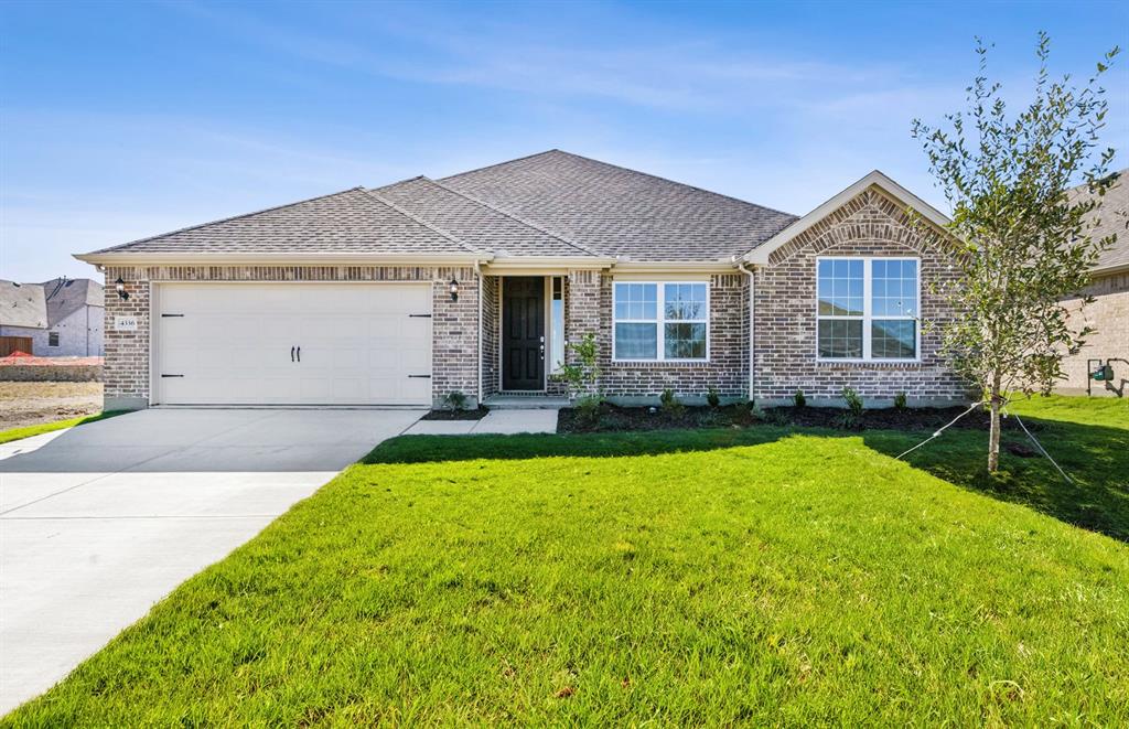 a front view of house with yard and green space