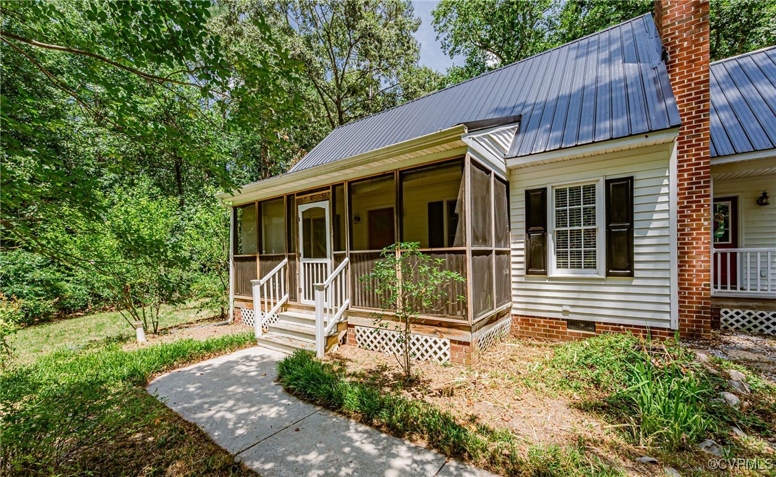 a view of a house with a small yard and wooden fence