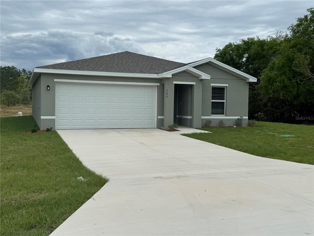 a front view of house with yard and trees