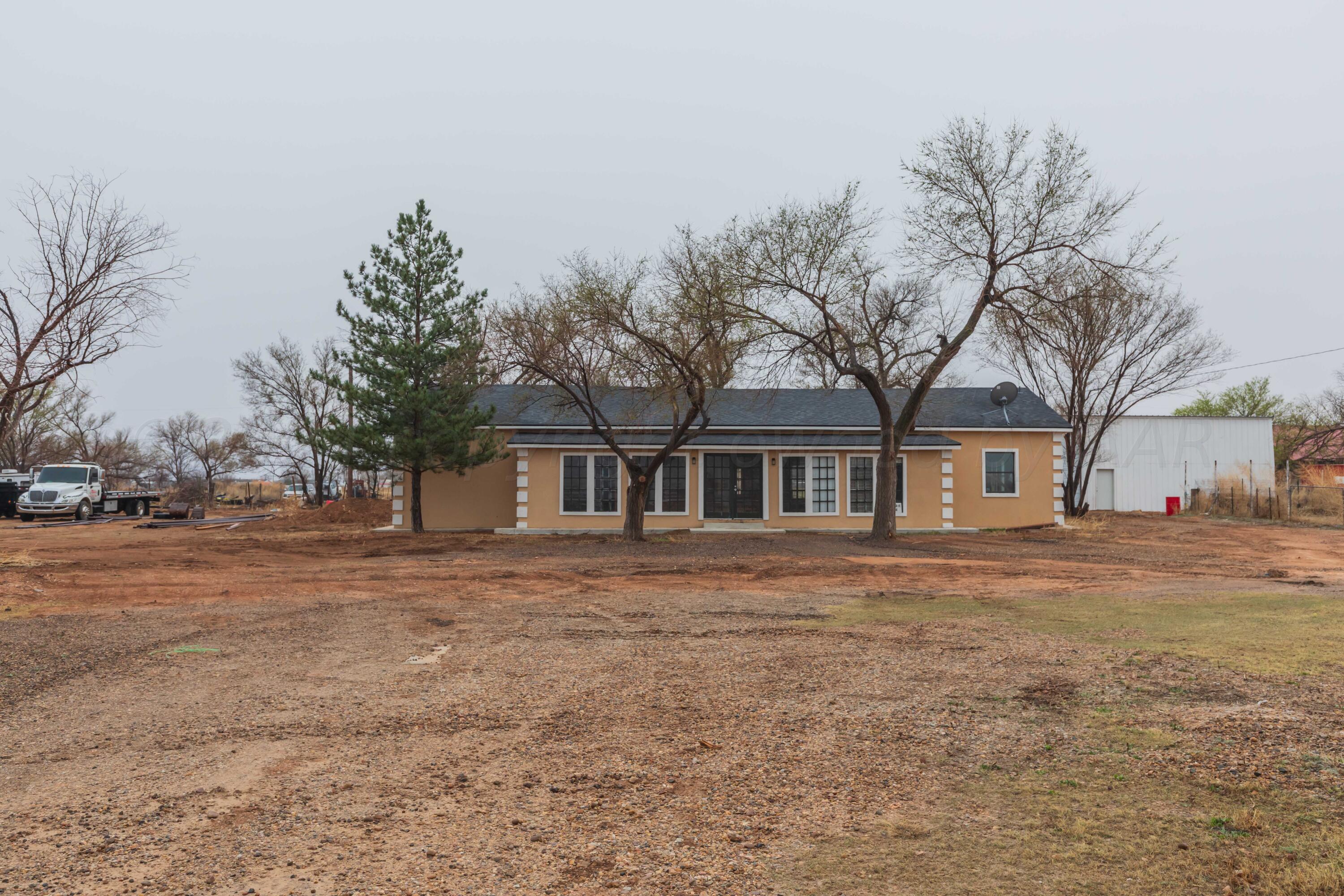 a front view of house with yard and trees