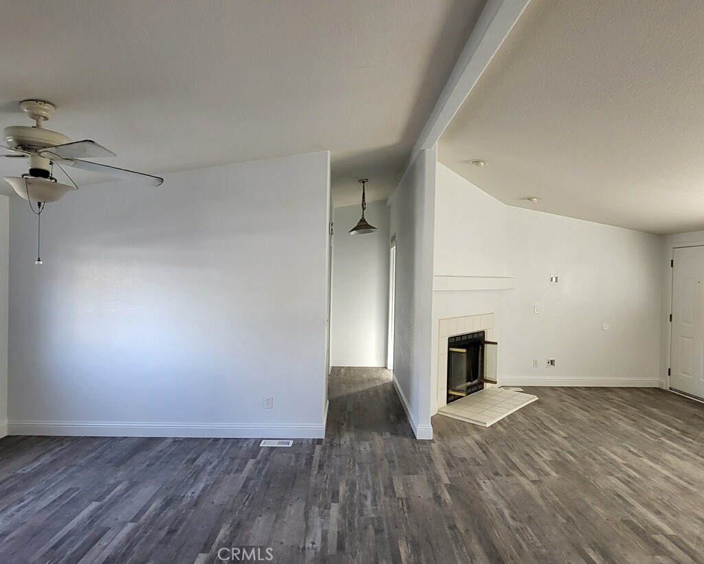 wooden floor in an empty room with a fireplace