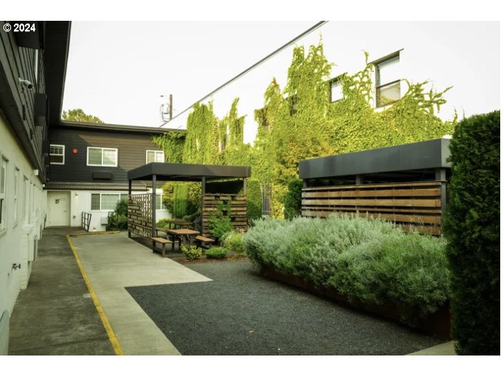 a backyard of a house with outdoor seating