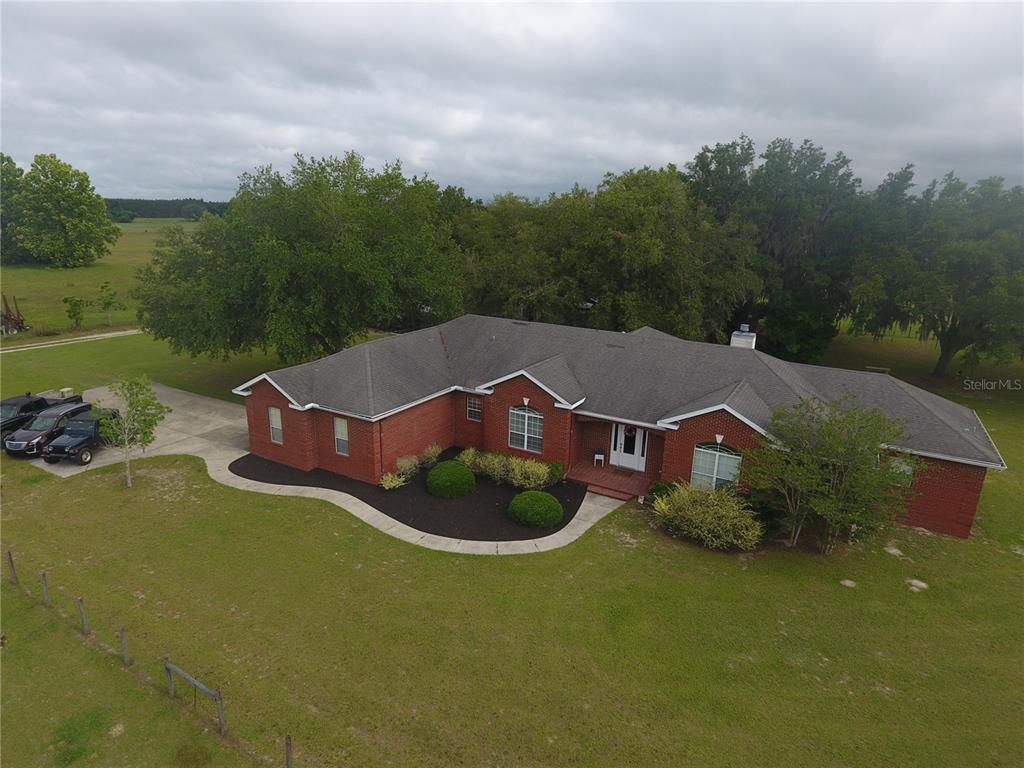 an aerial view of a house with garden space and street view