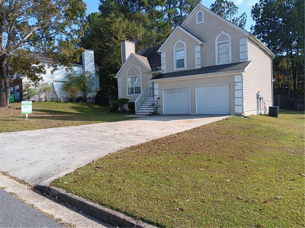 a front view of a house with a yard and garage