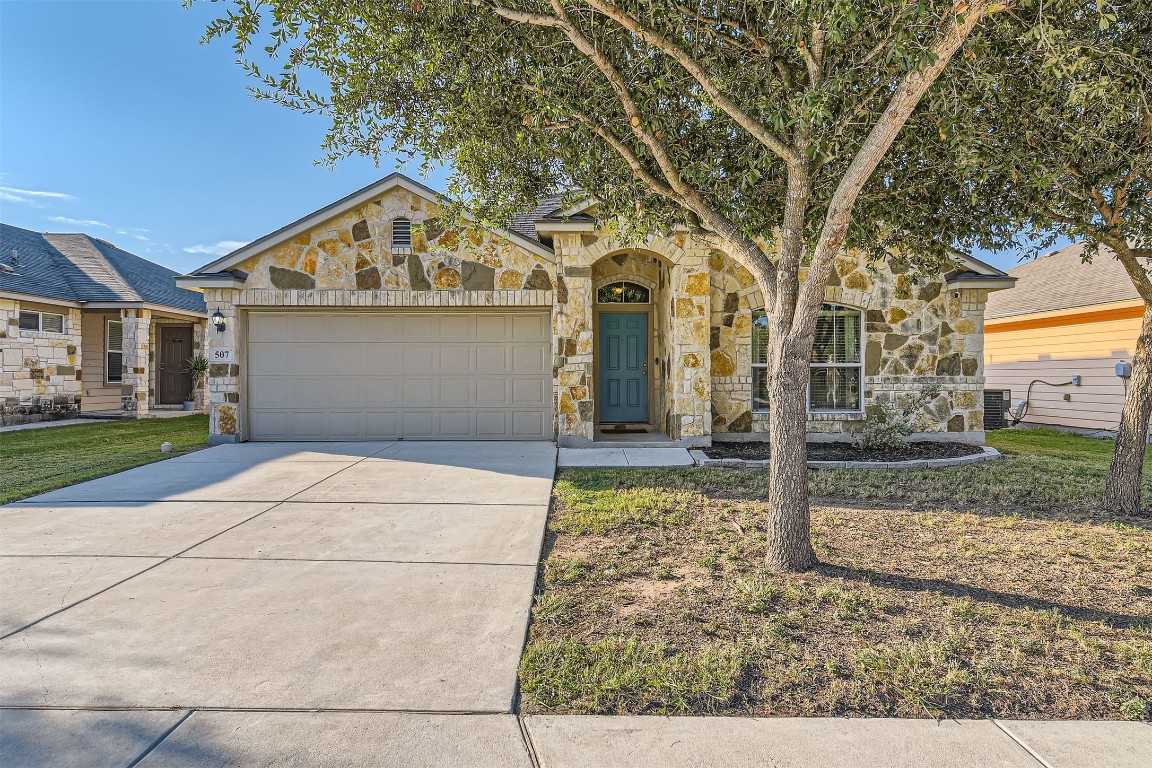 a front view of a house with a yard and garage