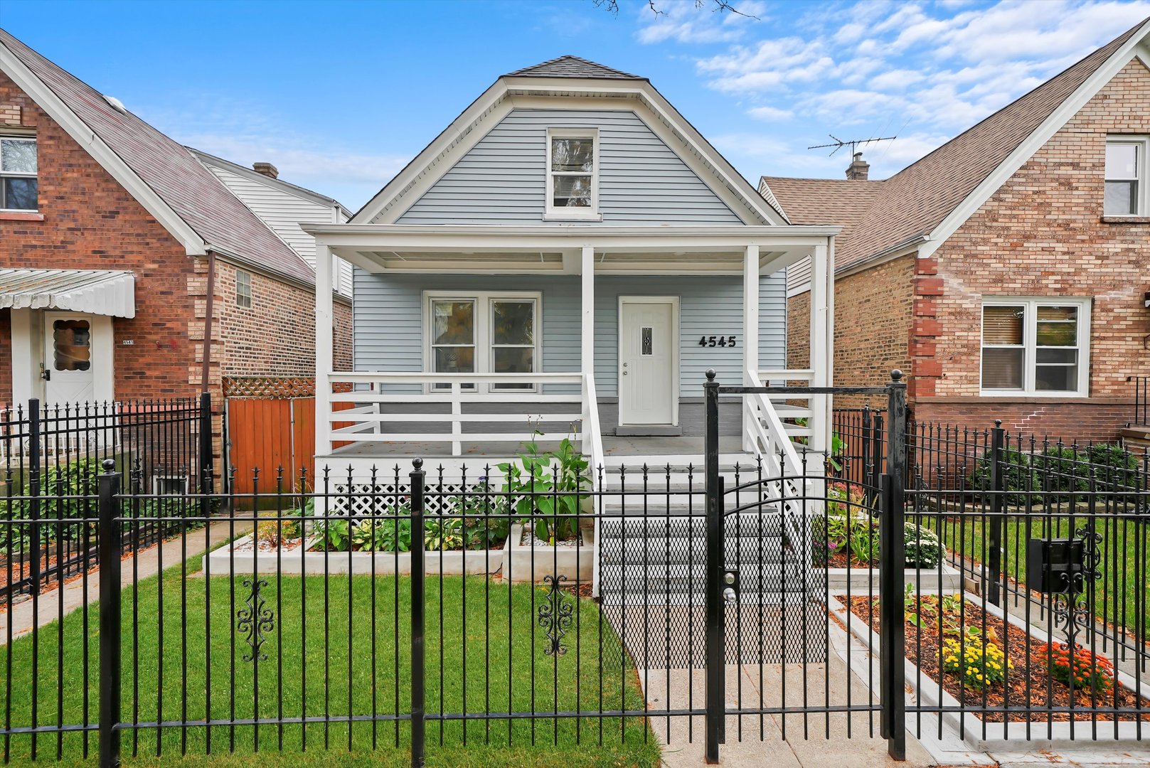 a front view of a house with a garden