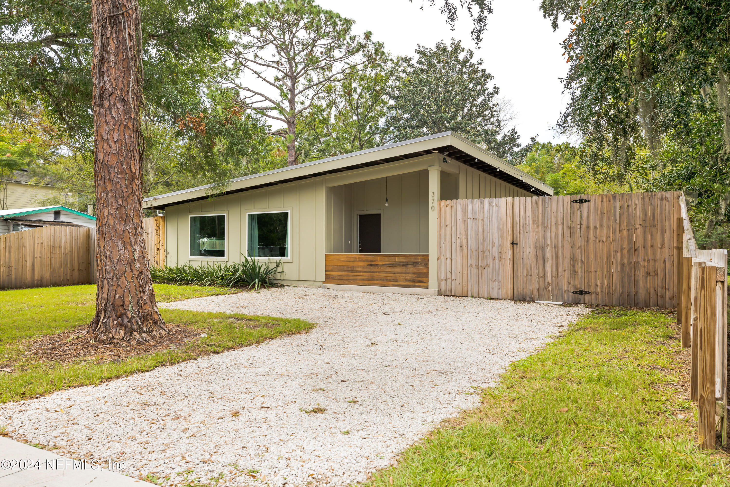 a front view of a house with a garden and yard