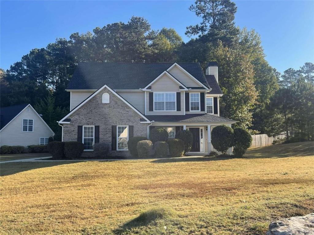 a front view of a house with a yard