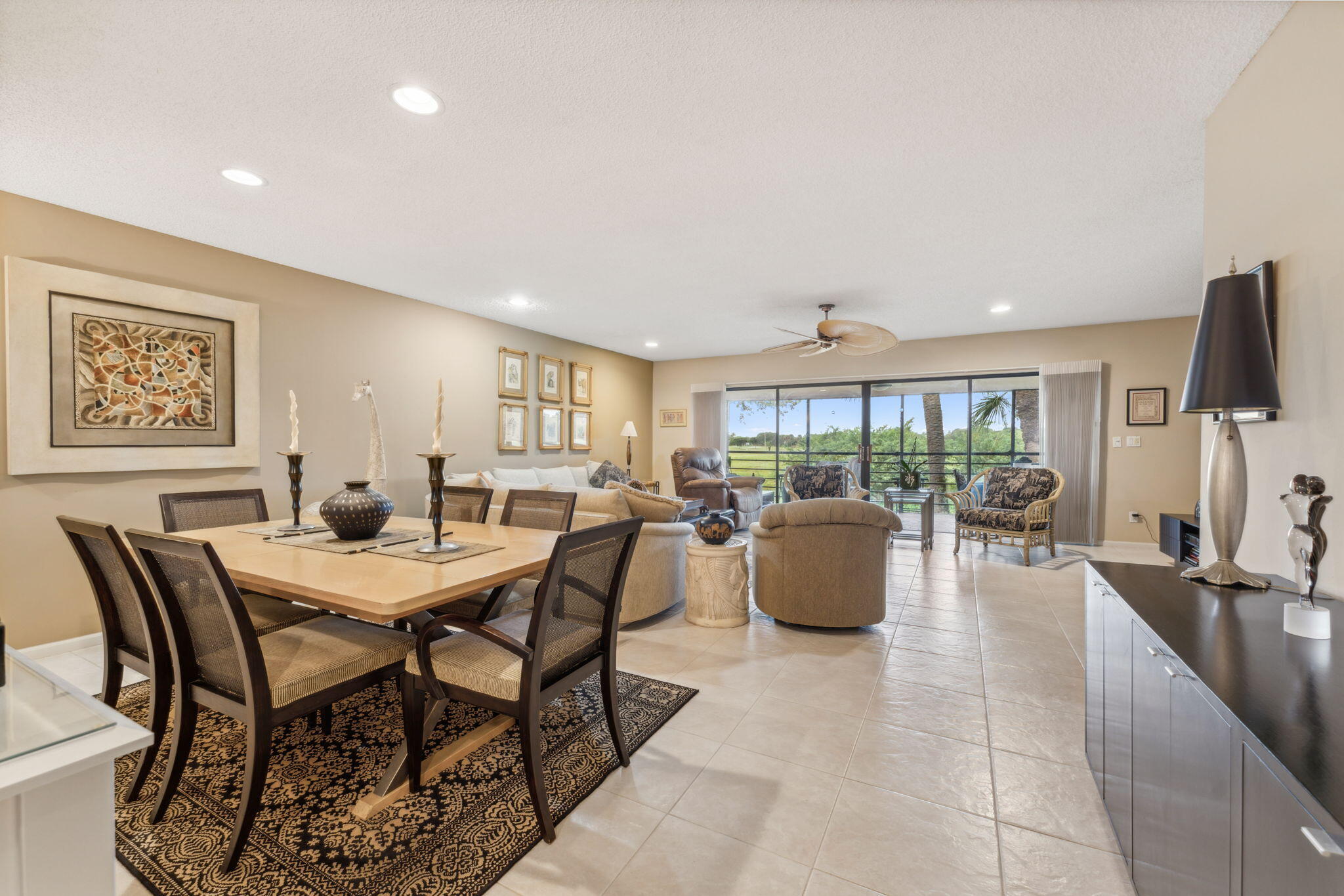 a dining room with furniture and a floor to ceiling window