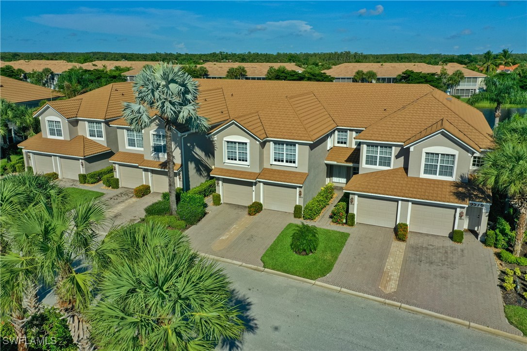 an aerial view of a house with a garden and lake view