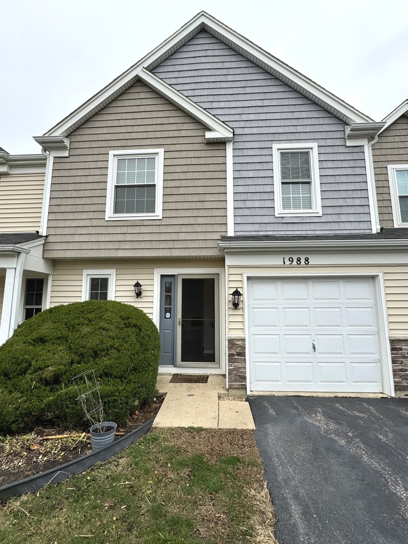 a view of a house with a yard and garage