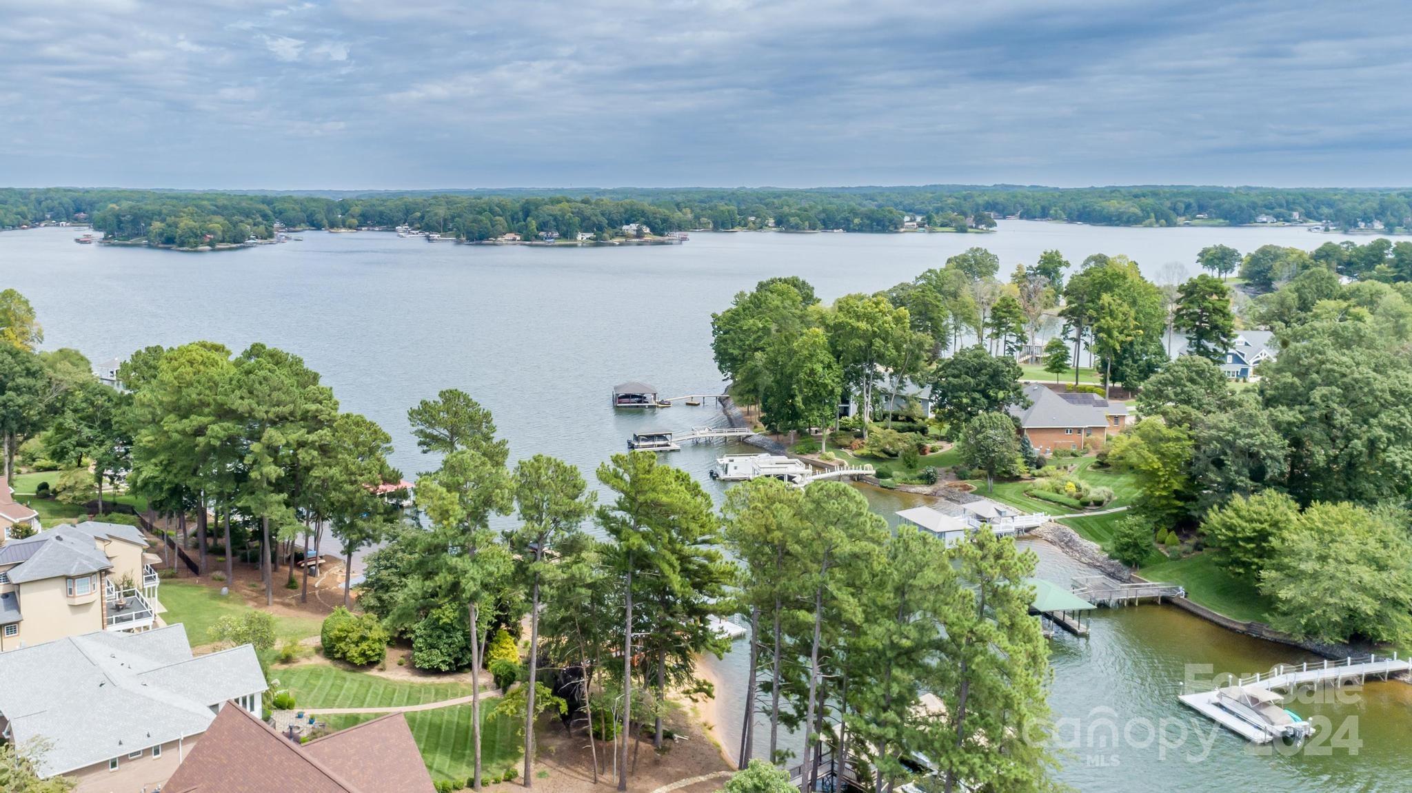 an aerial view of a houses with outdoor space and lake view