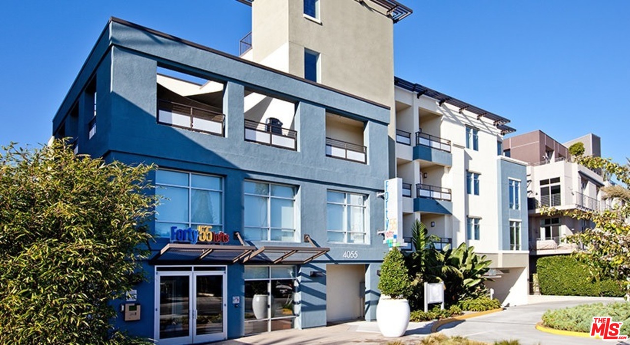 a front view of a residential apartment building with a yard