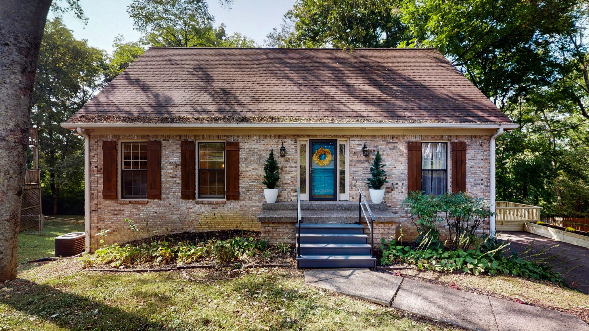 a front view of a house with garden