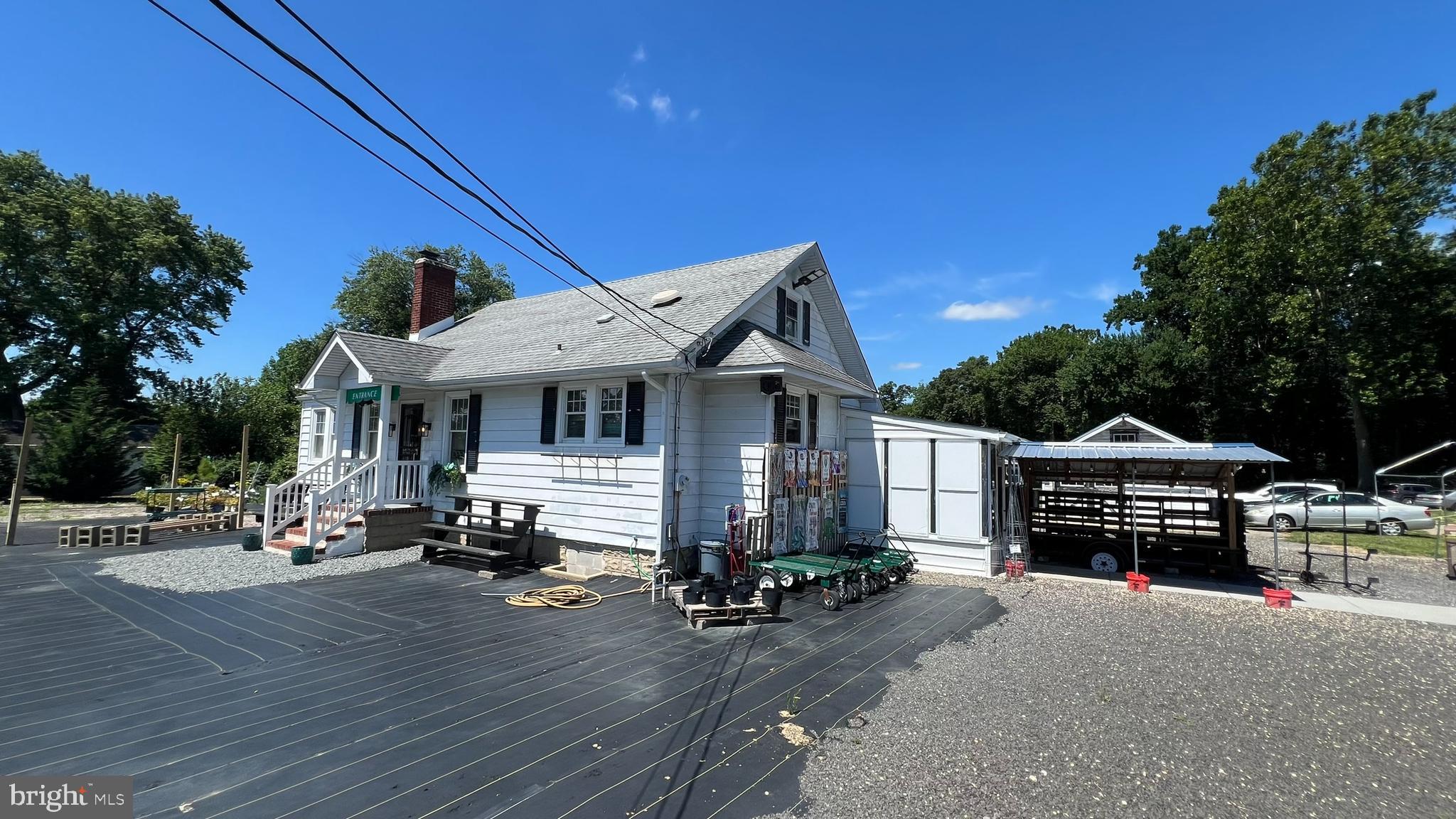 a view of a house with wooden deck and furniture