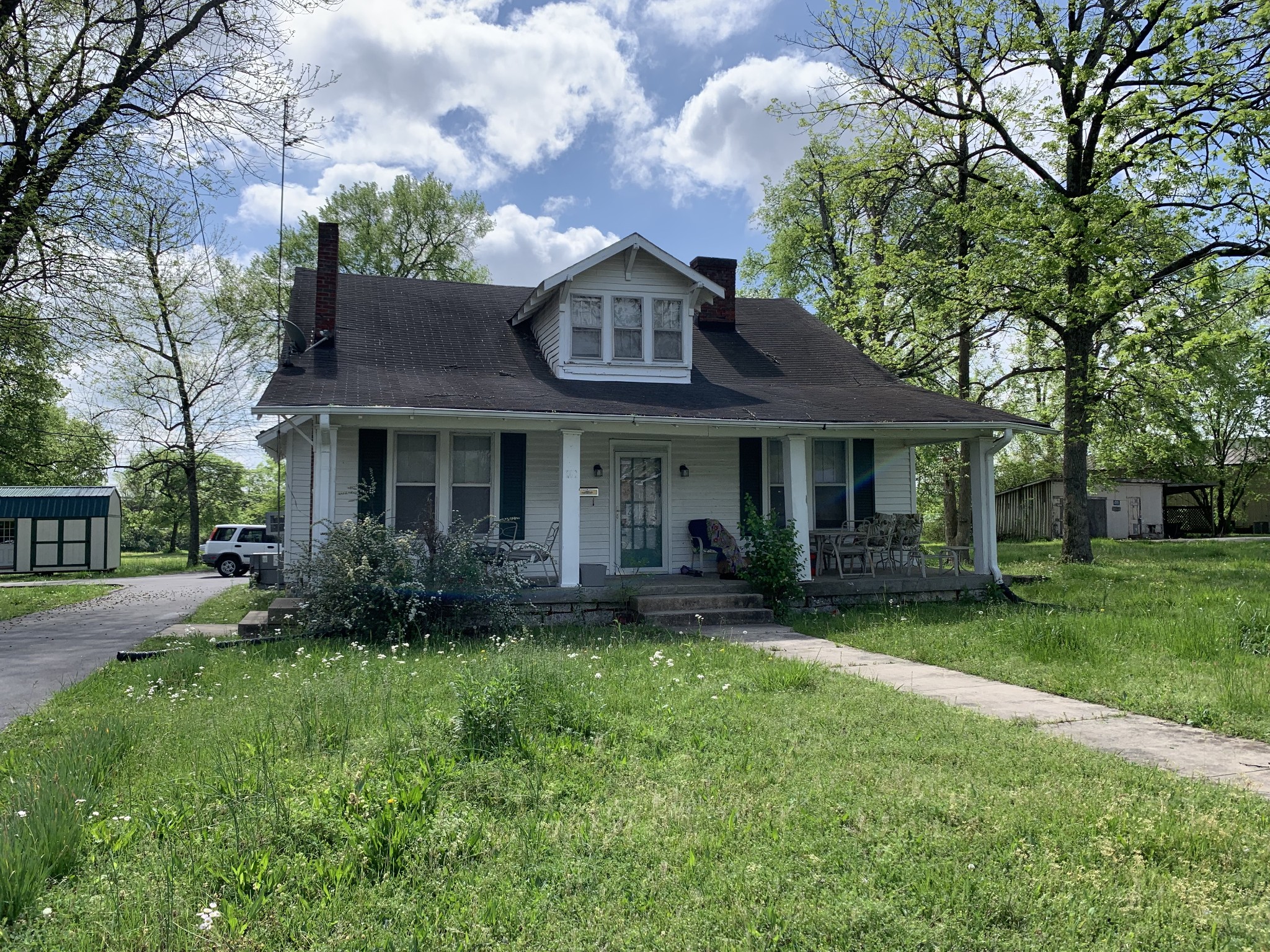 a front view of a house with garden and porch