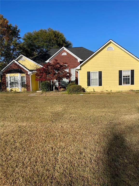 a front view of a house with a yard