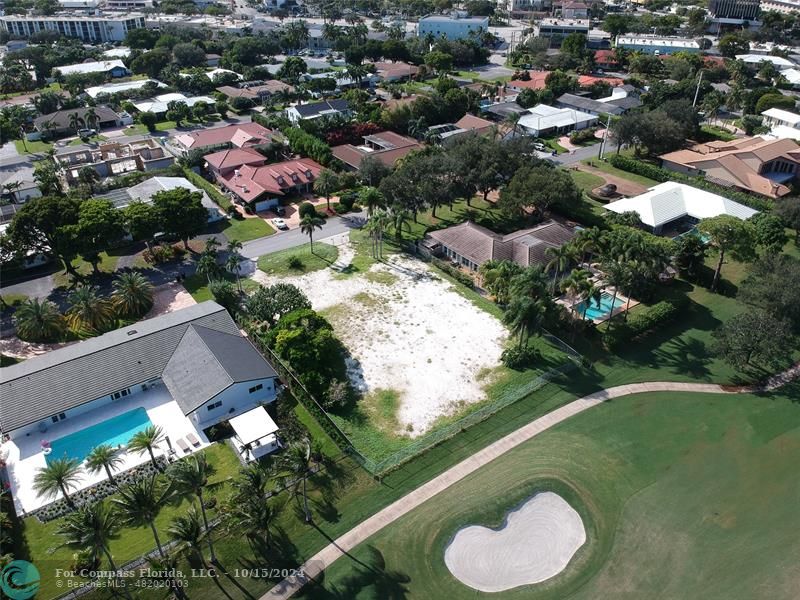 an aerial view of a residential houses with outdoor space and street view