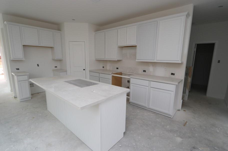 a kitchen with a sink a stove and cabinets