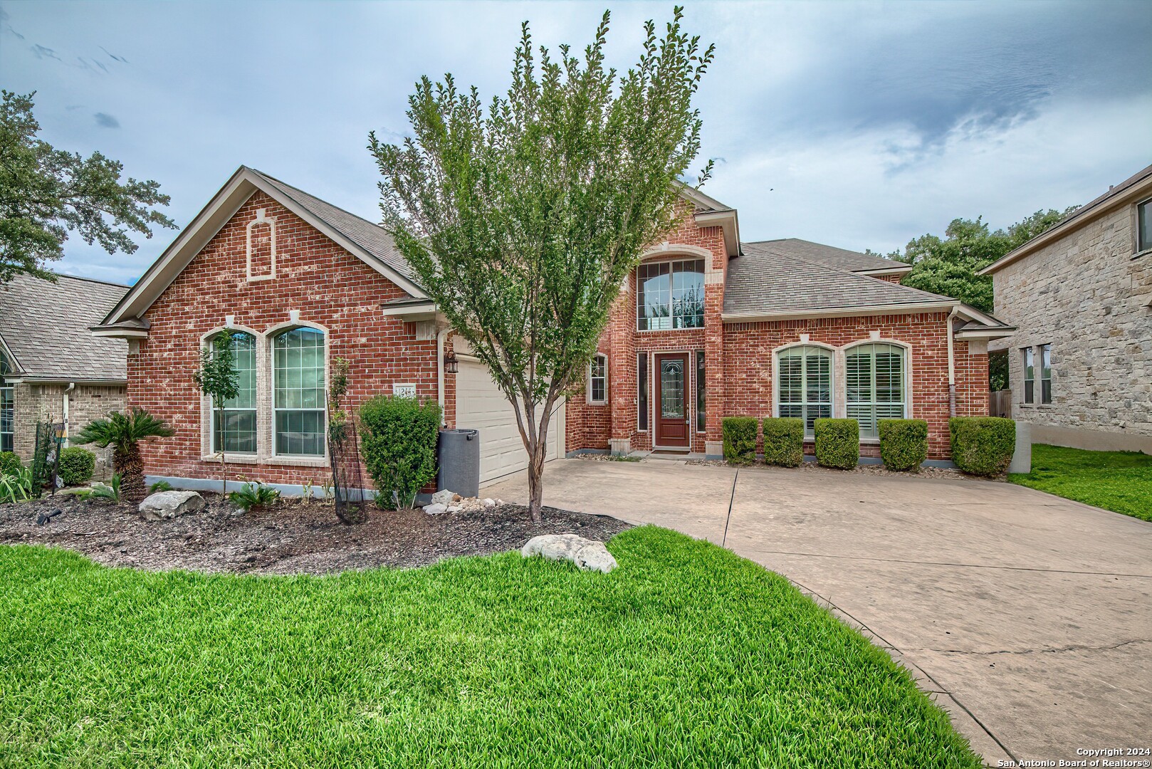 a front view of a house with a yard and porch