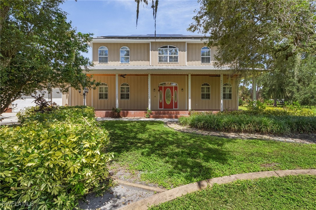 a front view of a house with garden